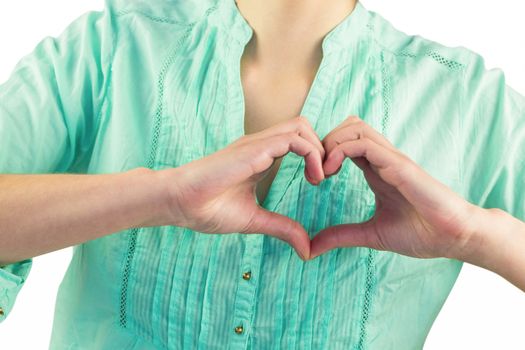 Mid section of woman making heart shape of fingers against white background