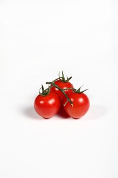 three cherry tomatoes on white background