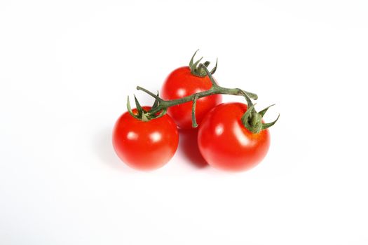 three cherry tomatoes on white background