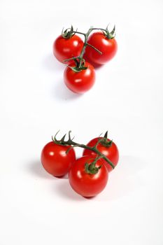 six cherry tomatoes on white