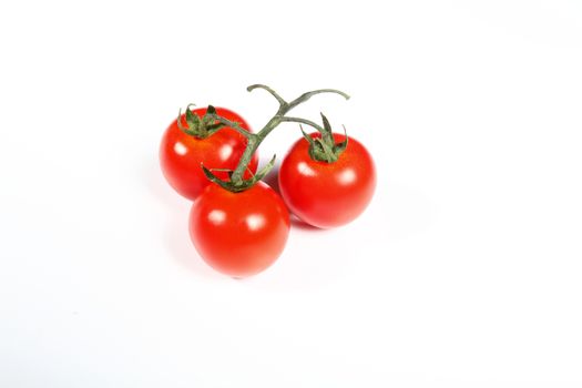 three cherry tomatoes on white background