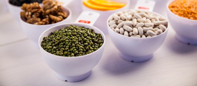 Portion cups of healthy ingredients on wooden table