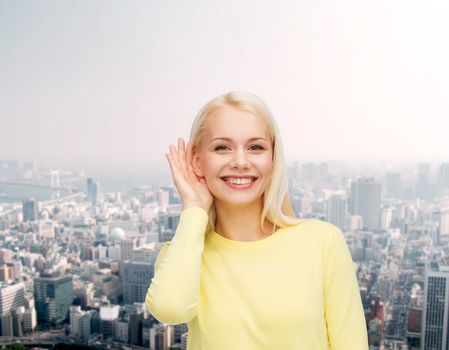 gossip, communication and people concept - smiling young woman listening to gossip