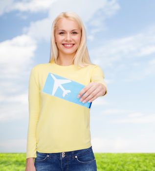 travel and transportation concept - smiling young woman with airplane ticket