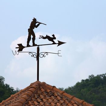 Weather vane with blue sky