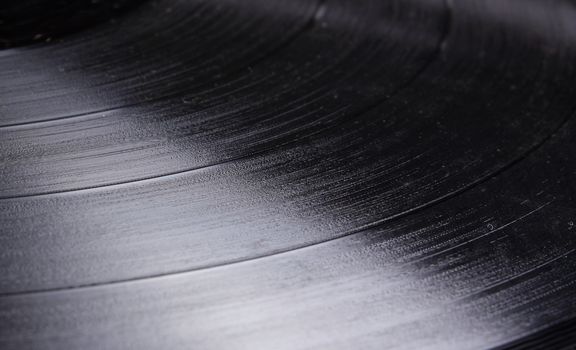 A background with a close up view of a Vinyl or LP or old gramophone record.
