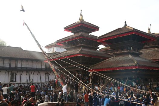 NEPAL, Kathmandu: Pole raised 	The erection of a wooden Indradhoj pole in Hanumandhoka�Durbar Square on September 25, 2015 marked the beginning of Indrajatra festival in Kathmandu, Nepal.  	Indrajatra is an eight day festival with a chariot procession dedicated to Goddess Kumari, Lord Ganesh and Bhairav, as well as worshiping Indra, the king of gods. 