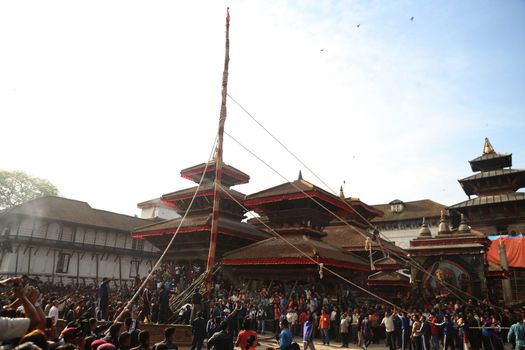 NEPAL, Kathmandu:  	The erection of a wooden Indradhoj pole in Hanumandhoka�Durbar Square on September 25, 2015 marked the beginning of Indrajatra festival in Kathmandu, Nepal.  	Indrajatra is an eight day festival with a chariot procession dedicated to Goddess Kumari, Lord Ganesh and Bhairav, as well as worshiping Indra, the king of gods. 