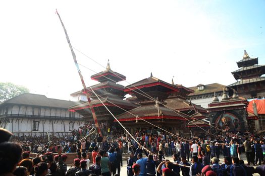 NEPAL, Kathmandu:  	The erection of a wooden Indradhoj pole in Hanumandhoka�Durbar Square on September 25, 2015 marked the beginning of Indrajatra festival in Kathmandu, Nepal.  	Indrajatra is an eight day festival with a chariot procession dedicated to Goddess Kumari, Lord Ganesh and Bhairav, as well as worshiping Indra, the king of gods. 