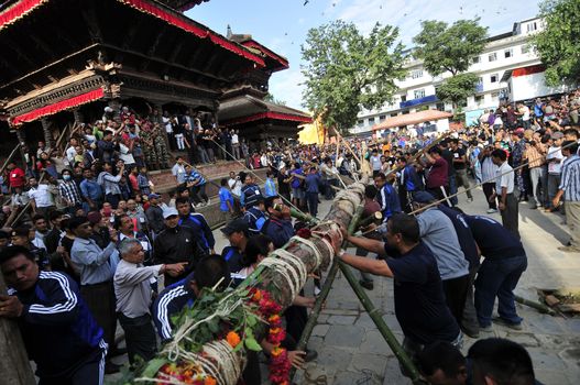 NEPAL, Kathmandu: 	The erection of a wooden�Indradhoj�pole in�Hanumandhoka�Durbar�Square on September 25, 2015 marked the beginning of�Indra�Jatra�festival in Kathmandu, Nepal.  	Indra�Jatra�is an eight day festival with a chariot procession dedicated to Goddess�Kumari, Lord�Ganesh�and�Bhairav, as well as worshiping�Indra, the king of gods. 