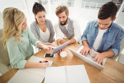 High angle view of business people working in office while sitting at desk