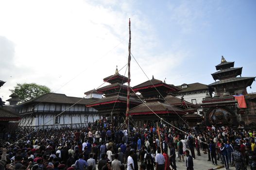 NEPAL, Kathmandu: 	The erection of a wooden�Indradhoj�pole in�Hanumandhoka�Durbar�Square on September 25, 2015 marked the beginning of�Indra�Jatra�festival in Kathmandu, Nepal.  	Indra�Jatra�is an eight day festival with a chariot procession dedicated to Goddess�Kumari, Lord�Ganesh�and�Bhairav, as well as worshiping�Indra, the king of gods. 