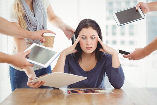 Businesswoman having headache while sitting at desk 