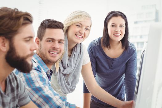 Portrait of cheerful business team working at desk in office