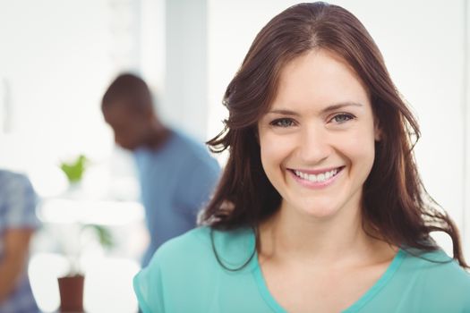 Portrait of smiling woman while standing at office