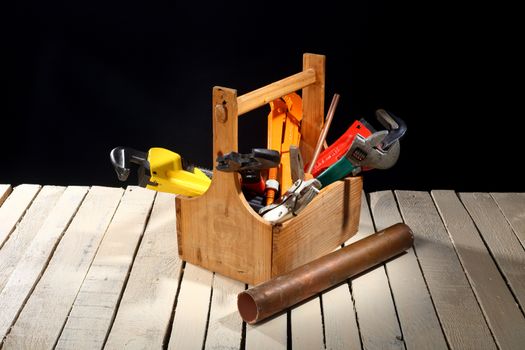 plumbing tools in wooden toolbox close up