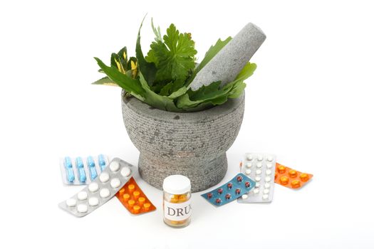 Mortar, pestle, herbs and pills over white. 