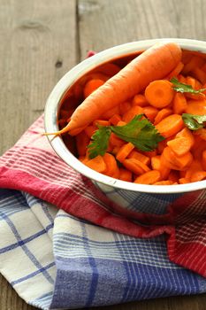 chopped carrots in bowl of steel , shallow dof 