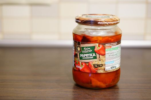 POZNAN, POLAND - SEPTEMBER 24, 2015: Red pepper in a glass jar standing on table
