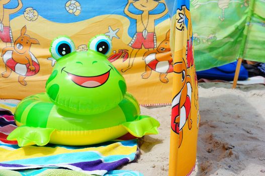 SIANOZETY, POLAND - JULY 21, 2015: Inflatable plastic toy ring in frog shape at a beach