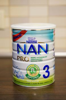 POZNAN, POLAND - SEPTEMBER 24, 2015: Nan Pro 3 baby milk powder in a container