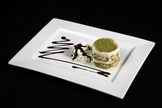 sweet green tea in white plate on a black background