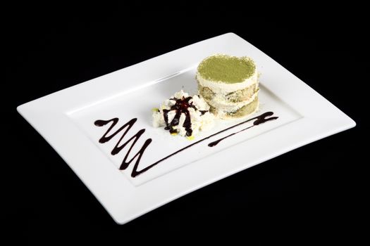 sweet green tea in white plate on a black background