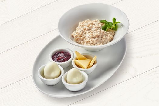 English breakfast with porridge and hard-boiled eggs