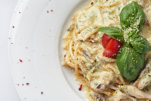 Italian spaghetti with sauce, mushrooms and basil leaf