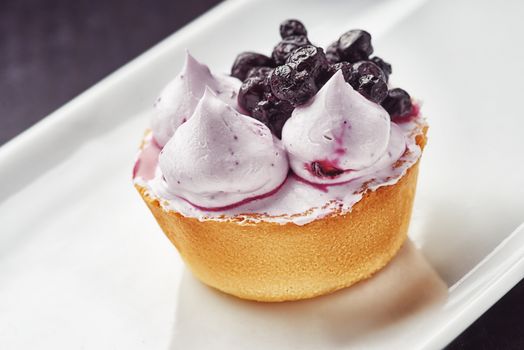 Beautiful sugar cream Cupcake dessert with blackberry