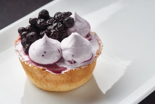 Beautiful sugar cream Cupcake dessert with blackberry
