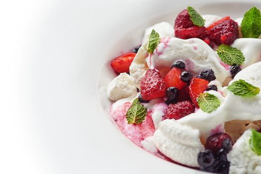 delicious ice cream with fruit, berries and pieces of meringue