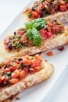 Salsa Bruschetta with salmon and vegetables on white background