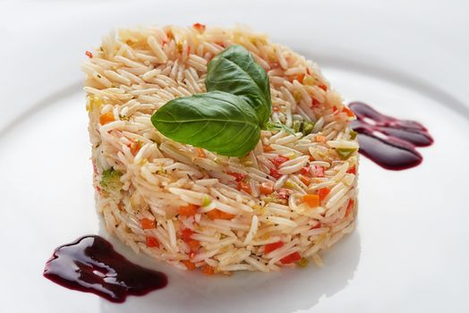 basmati rice on a white plate with basil leaves