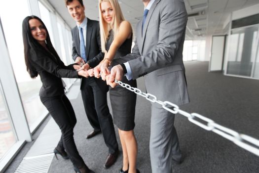 Businessmen pulling chain, teamwork togetherness concept