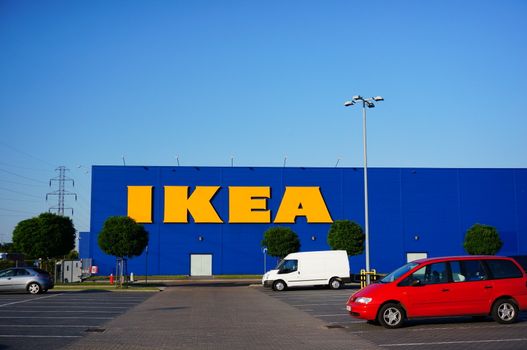 POZNAN, POLAND - AUGUST 01, 2015: Parked cars on a parking lot in front of a IKEA building in Poznan, Poland