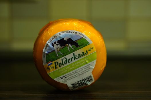 POZNAN, POLAND - AUGUST 25, 2015: Dutch polderkaas cheese with comin in plastic foil