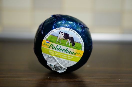 POZNAN, POLAND - AUGUST 25, 2015: Dutch polderkaas cheese in plastic foil