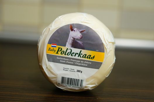 POZNAN, POLAND - AUGUST 25, 2015: Dutch polderkaas goat cheese in plastic foil