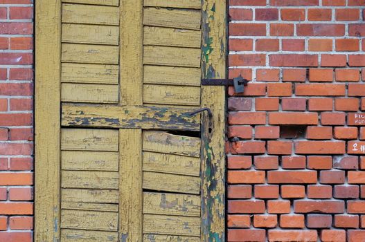 Wooden locked door on stone brick wall