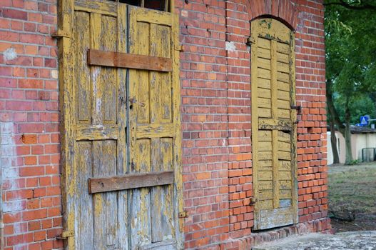 Wooden locked door on stone brick wall