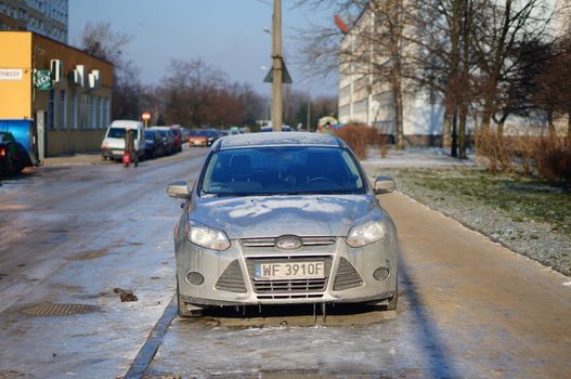 POZNAN, POLAND - JANUARY 25, 2014: Parked car covered with ice on a cold winter day
