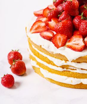 Layered, strawberry cake on the table