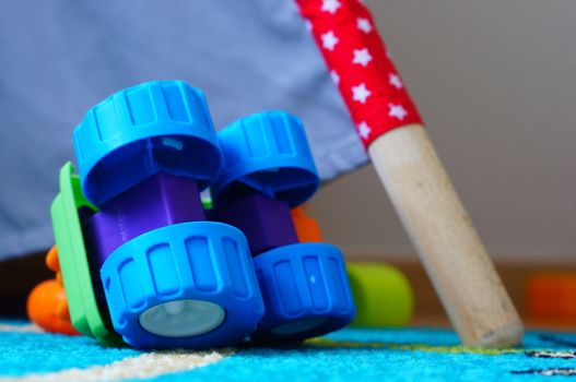 Plastic toy car lying upside down on the floor