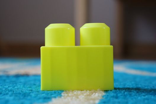Yellow toy block with two pins