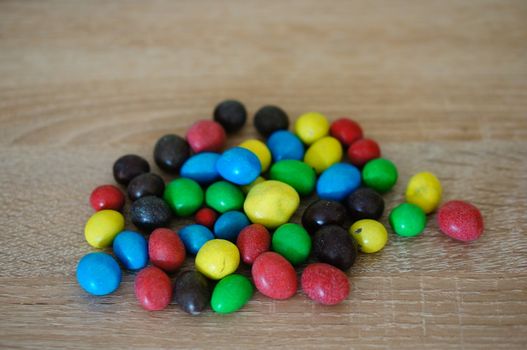 Chocolate peanuts mix on wooden background