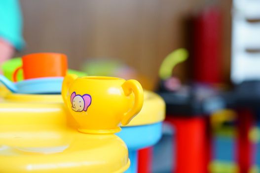 Yellow toy cup with elephant symbol on table