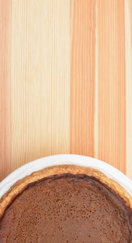 Thanksgiving pumpkin pie with wood grain copy space above