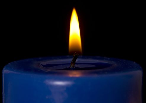 Macro shot of a single candle flame.