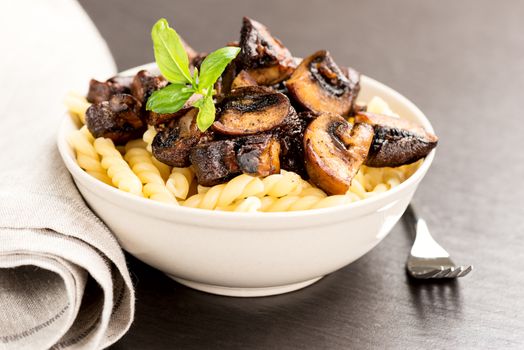 Fusilli with mushrooms, italian cuisine